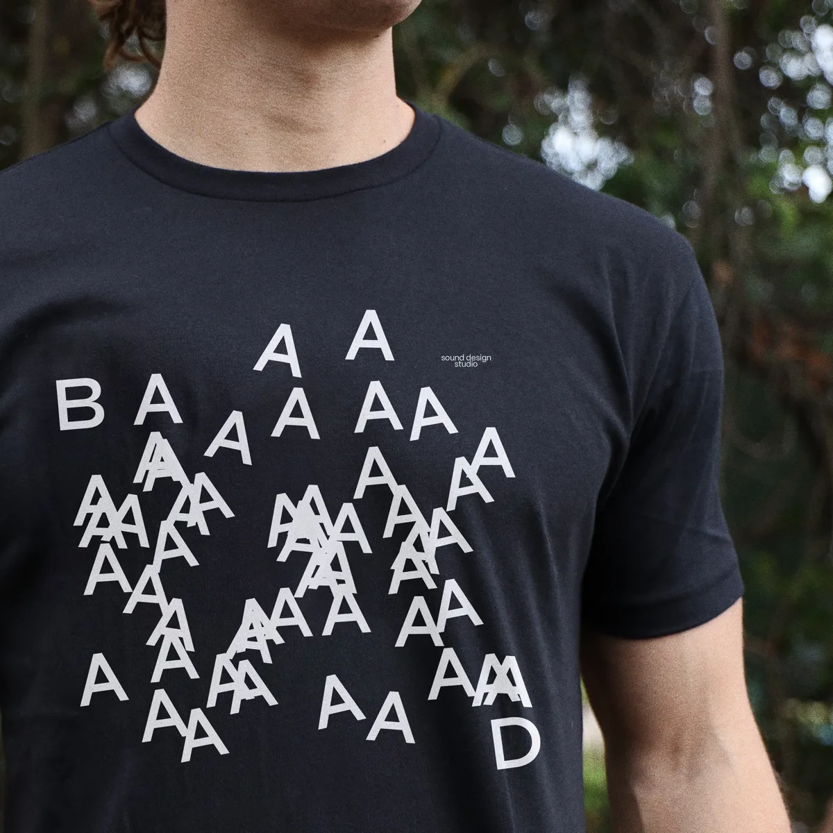 A navy T-shirt printed with a scatter of the letter A.