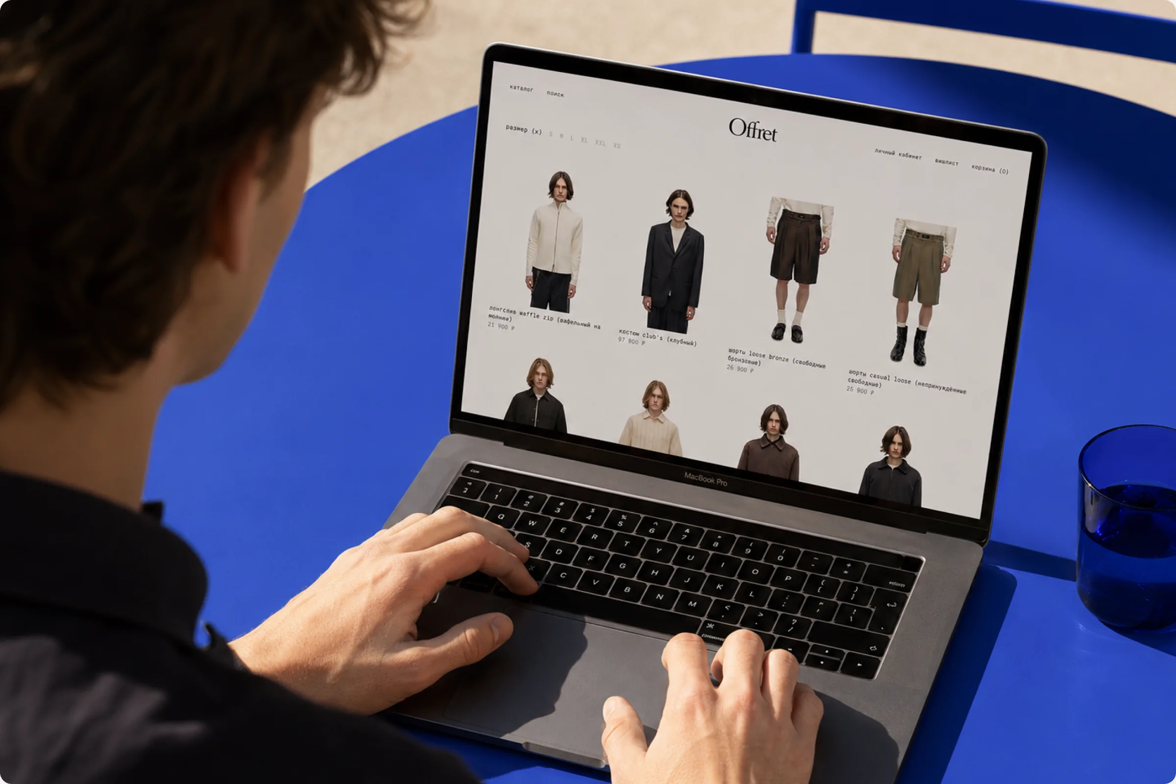 Someone browsing the Offret catalogue on a laptop: a grid of product cards four across.
